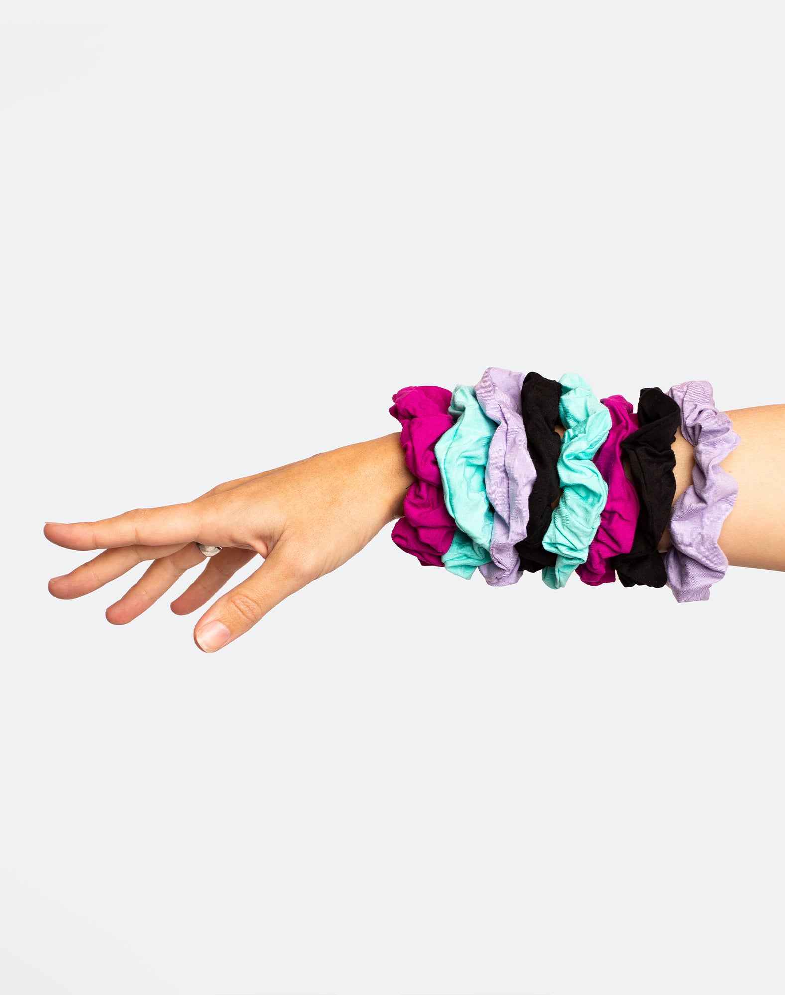 A collection of elastic hair scrunchies in various colours