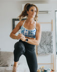 Fit, strong mother exercising in a blue and white print nursing running bra