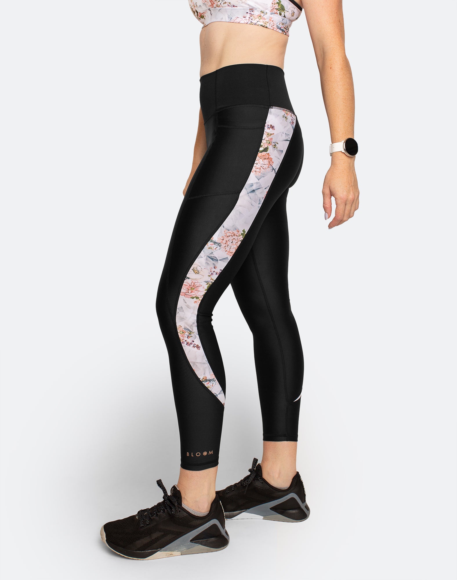 Side view of active mum wearing black postpartum compression leggings