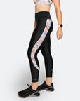 Side view of active mum wearing black postpartum compression leggings