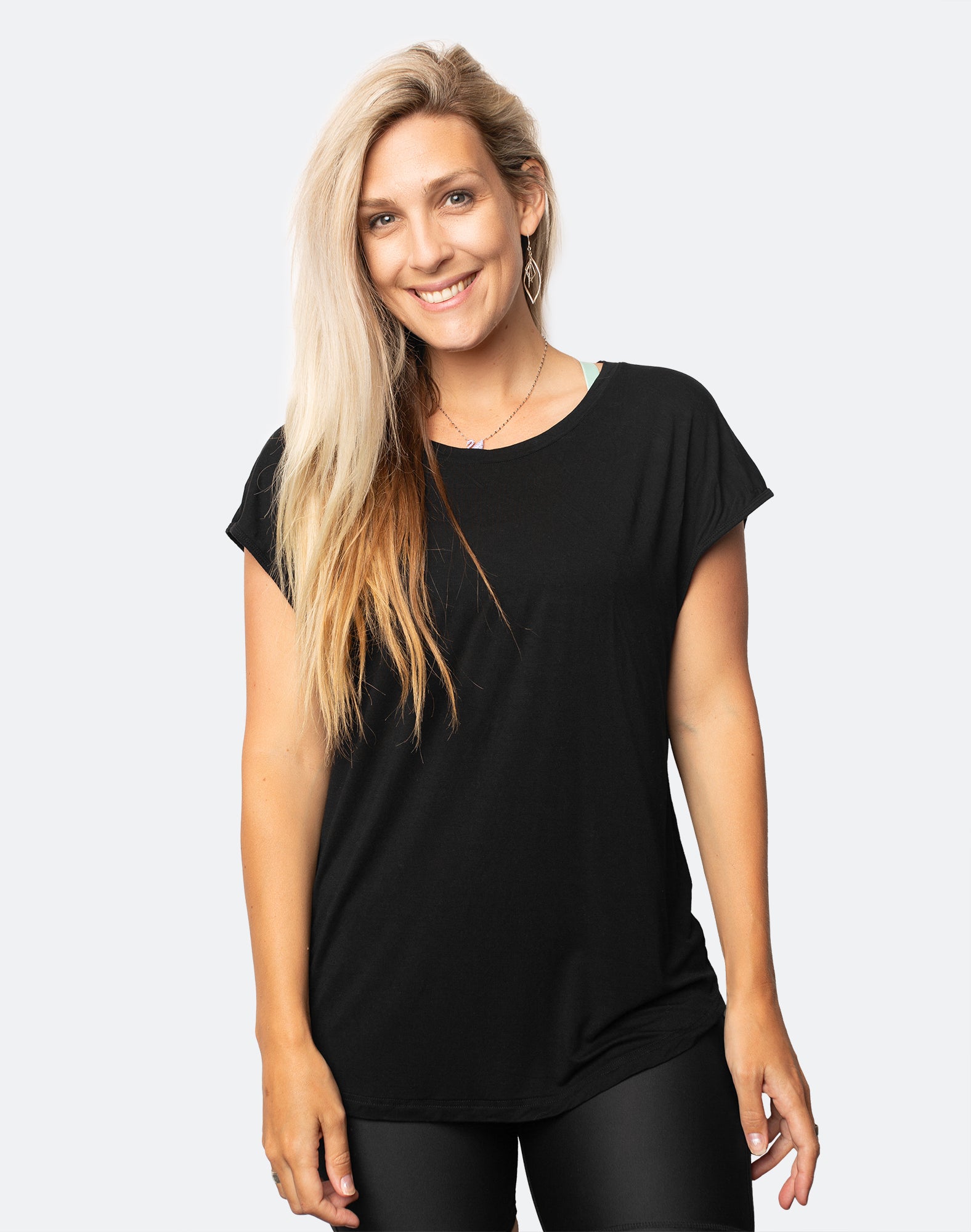 active happy mum wearing a relaxed fit black tee with wide armholes for breastfeeding