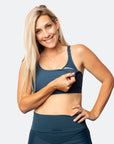 Front view of active mum unclipping nursing sports bra