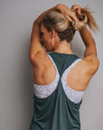 Happy mum wearing a dark green maternity tank