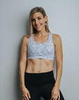 Fit model wearing women's racerback sports crop bra